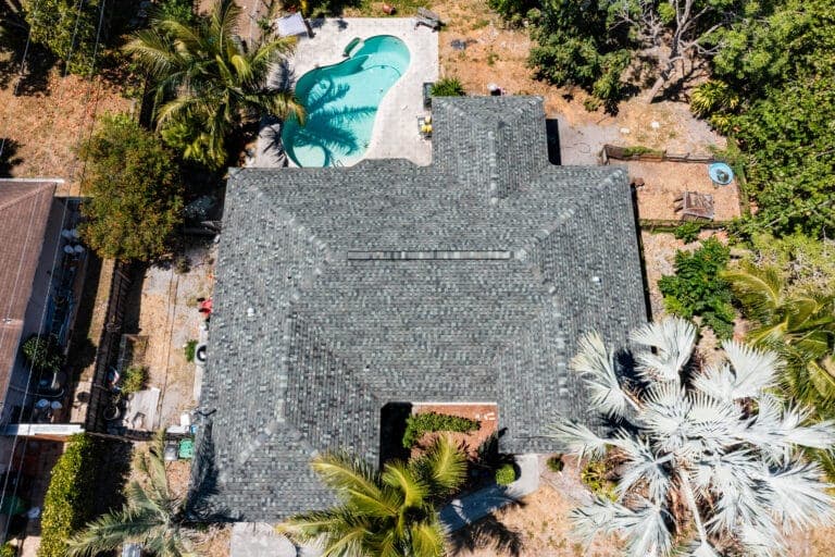 Aerial view of a gray architectural shingle roof on a Florida pool home