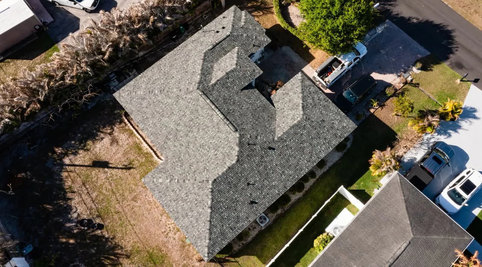 Aerial view of a home with a gray dimensional shingle roof