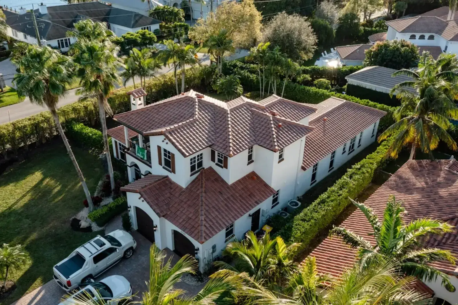 Aerial view of a large Mediterranean-style home with a terracotta barrel tile roof