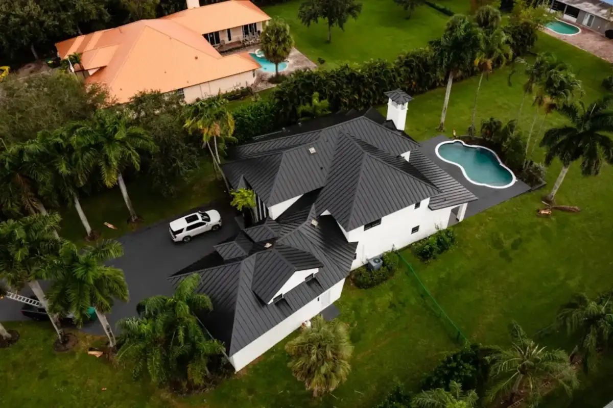 Aerial view of a home with a dark standing seam metal roof