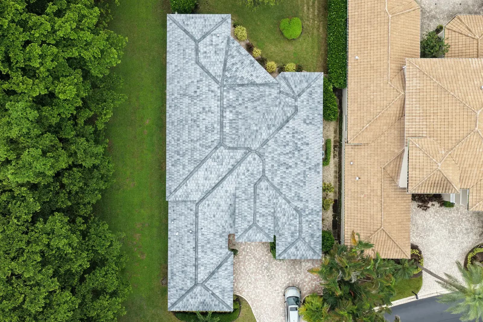 Top-down aerial view of a finished light gray flat tile re-roof