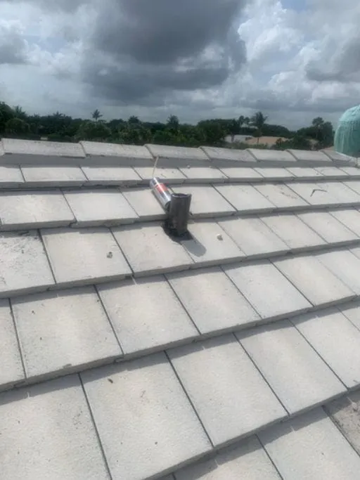 Close-up of a concrete flat tile roof with a flashed vent