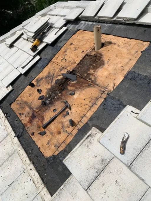 Close-up of a roof deck repair with exposed wood patch