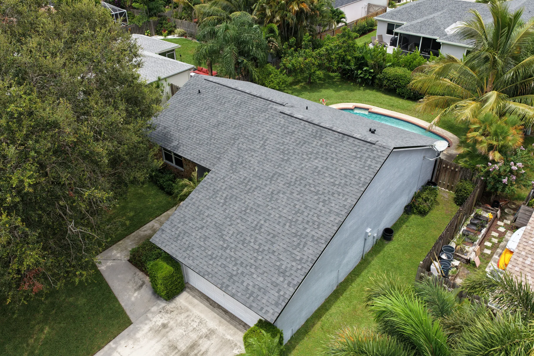 Aerial view of a Florida home with a gray architectural shingle roof