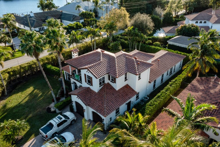 Aerial view of a home with a new tile roof installed by All-Type Roofing Services