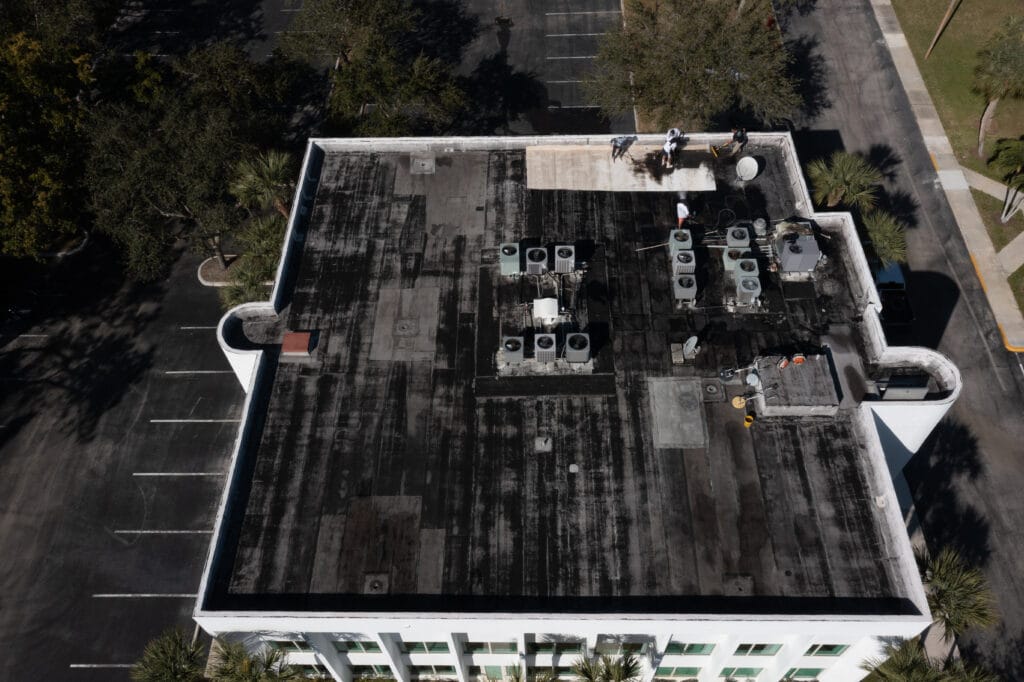 Aerial view of a roof before maintenance work by All-Type Roofing Services